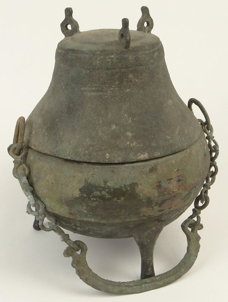 Han Dynasty (206 BC-220 CE) Bronze 3 Footed Lidded: Han Dynasty (206 BC-220 CE) Bronze 3 Footed Lidded Food Storage Vessel with Chain For Hanging. Surface Wear and Oxidation Consistent with Age Otherwise in Good Condition. Measures 10 Inches Tall, 9 In