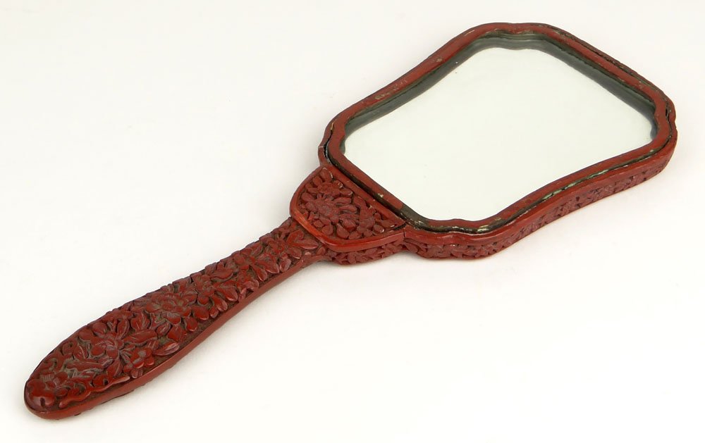 Chinese Cinnabar Lacquer Hand Mirror. Unsigned. Minor: Chinese Cinnabar Lacquer Hand Mirror. Unsigned. Minor Losses, Rubbing and Surface Wear Consistent with Age and Normal use Otherwise Good Condition. Measures 11-1/8 Inches Long and 4-1/2 Inches Wide. S