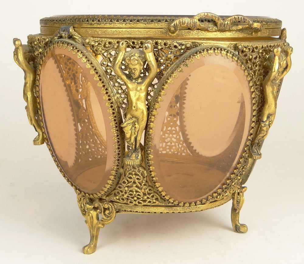 Mid 20th Century Gilt Metal and Amber Glass Dresser Box: Mid 20th Century Gilt Metal and Amber Glass Dresser Box with Relief Standing Nude Decoration. Unsigned. Rubbing Otherwise Good Condition. Measures 6 Inches Tall and 6-3/4 Inches Wide. Shipping $46.00