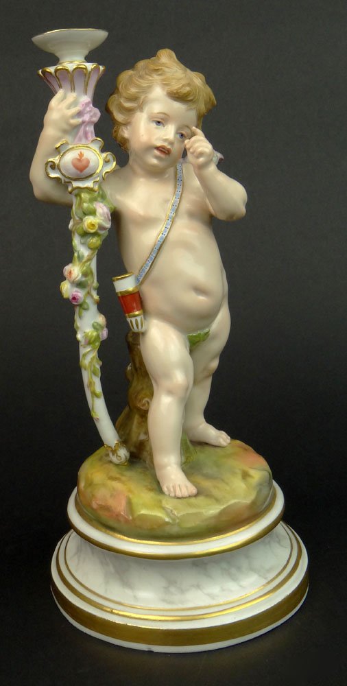 20th C Meissen Porcelain Cherub Figurine. Signed on: 20th C Meissen Porcelain Cherub Figurine. Signed on Bottom with Crossed Swords Mark Underglaze. Light Wear or in Otherwise Good Condition. Measures 7-3/4 Inches Tall. Shipping $45.00