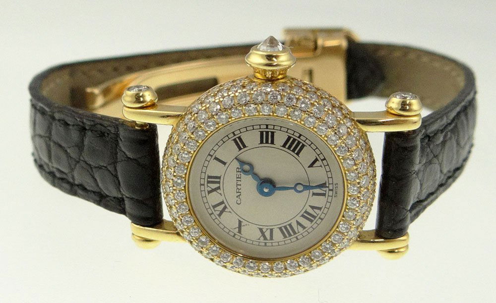 Ladies Cartier 18 Karat Yellow Gold and Diamond Watch.: Ladies Cartier 18 Karat Yellow Gold and Diamond Watch. Swiss Made With a Quartz Movement. 18K Yellow Gold Case, 18K Yellow Gold Deployment Clasp. Leather Strap. Four 940 Rows of Pave Set Round Brillia
