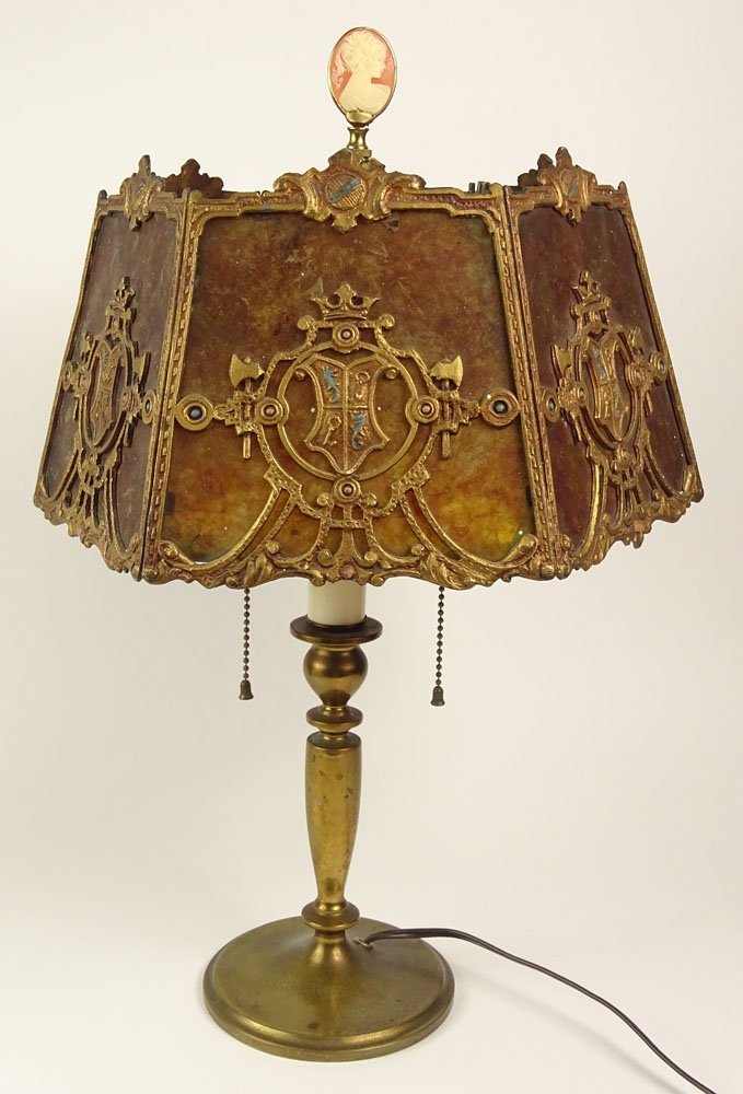 Antique (Six) 6 Paneled Mica-Shaded Desk Lamp. The: Antique (Six) 6 Paneled Mica-Shaded Desk Lamp. The Shade with Gilt Metal Decoration depicting Crests. The Lamp Base of Brass with Cameo Finial. Unsigned. Wear and Surface Cracks to Mica Shade. Lamp Me