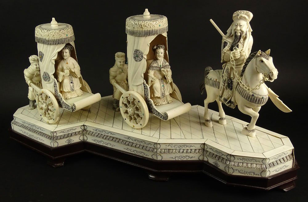 Large Chinese Carved and Inked Ivory Sculpture on Wood: Large Chinese Carved and Inked Ivory Sculpture on Wood Base, Ladies in Sedan Carts with Escort on Horseback. Unsigned. Minor Age Splits Otherwise Good Condition. Measures 12-1/2 Inches Tall and 30 Inc
