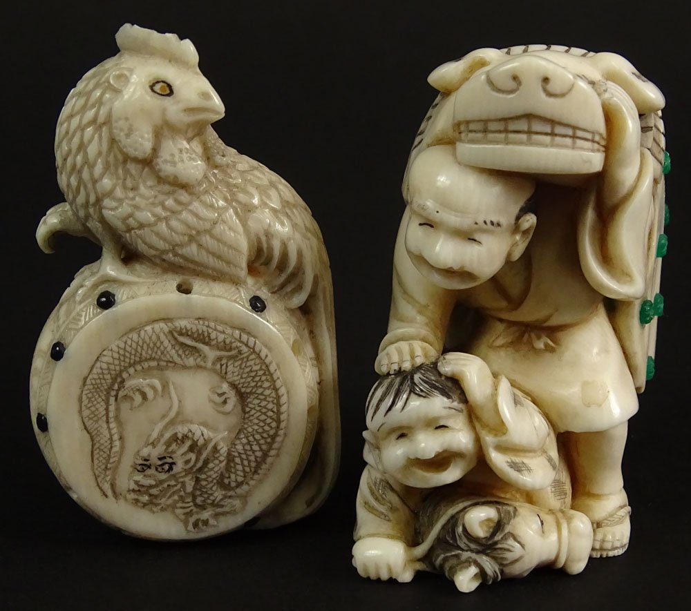 Lot of Two (2) Japanese Carved Ivory Netsukes. Both: Lot of Two (2) Japanese Carved Ivory Netsukes. Both with Applied Enamel Decoration. Man & Child, One with Mythical Beast Cloak 1-3/4 Inches Tall; One a Chicken on a Drum. Both Signed With Character Ma
