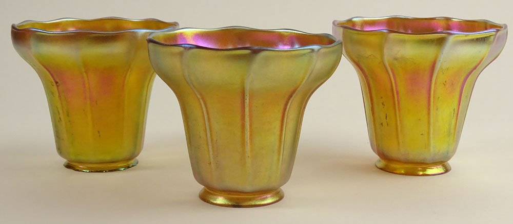 Lot of Three (3) Antique Tiffany Favrile Iridescent: Lot of Three (3) Antique Tiffany Favrile Iridescent Gold Luster Shades. Signed L.C.T. Minor Rim Chips at Base , Light Scratches or Good Condition. Measures 4-1/2 Inches. Shipping $85.00