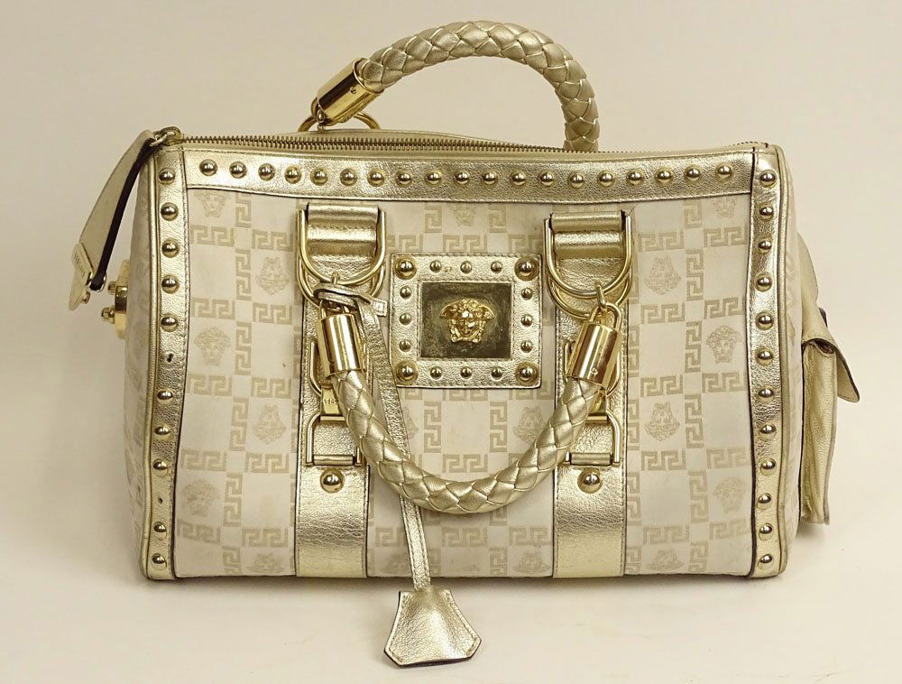 Versace Fabric and White Gold Leather Handbag with Gold: Versace Fabric and White Gold Leather Handbag with Gold Tone Metal Hardware. Used Condition, Soiling to Fabric, Missing Three (3) Studs. Measures 8-1/4 Inches Tall and 14 Inches Wide. Shipping $42.00
