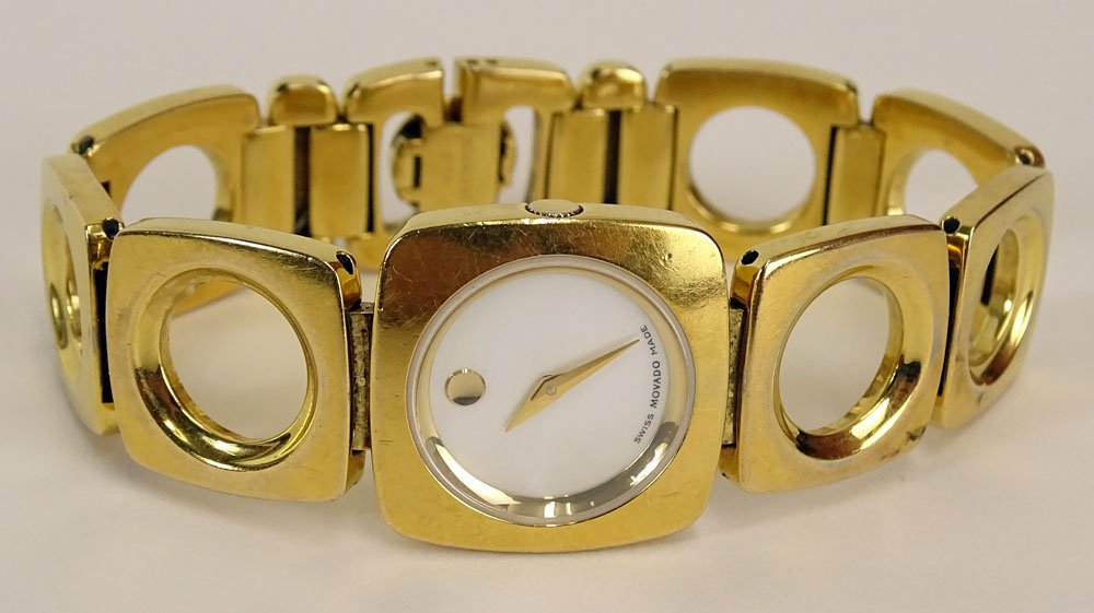 Lady's Vintage Movado Gold Tone Bracelet Quartz Watch: Lady's Vintage Movado Gold Tone Bracelet Quartz Watch with Mother of Pearl Dial. Running. The Gallery does Not warranty the running condition or watches. Surface Wear from Normal Use Otherwise Good Co