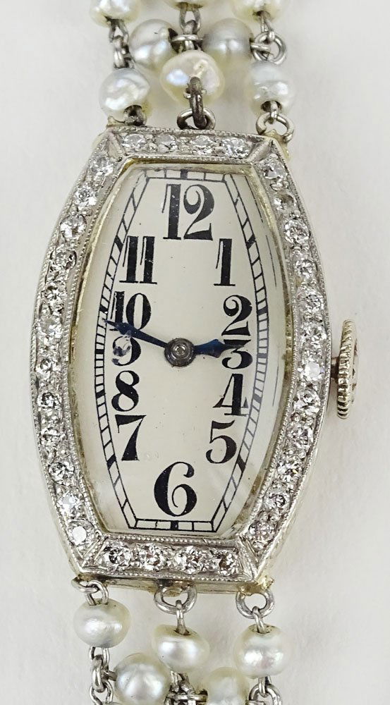 Lady's Edwardian platinum, diamond and seed pearl: Lady's Edwardian platinum, diamond and seed pearl Movado Swiss bracelet watch. Signed Movado and Swiss. Not running, needs servicing. Case in good condition. Case measures 24mm x 15mm. Bracelet measur