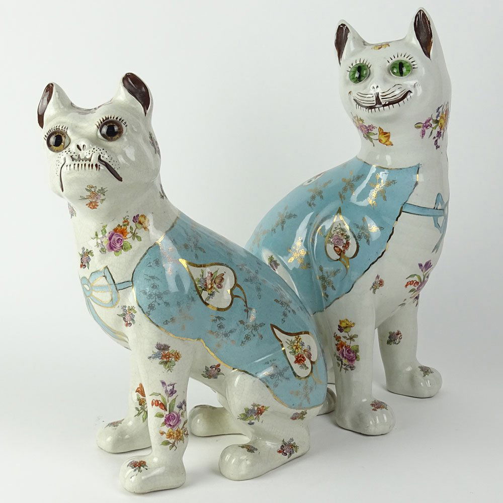 A pair of comical pottery figures of a seated cat and a (1 of 10)