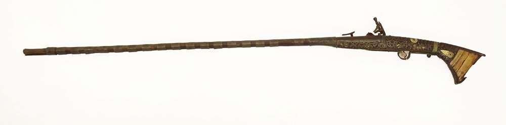 19th Century Berber Long Gun Musket from the Atlas: 19th Century Berber Long Gun Musket from the Atlas Mountain Region of Morocco with Silver Mounts and Bone Inlay. Antique Condition. Losses, Corrosion. Measures 63 Inches Long. Third Party Shipping.