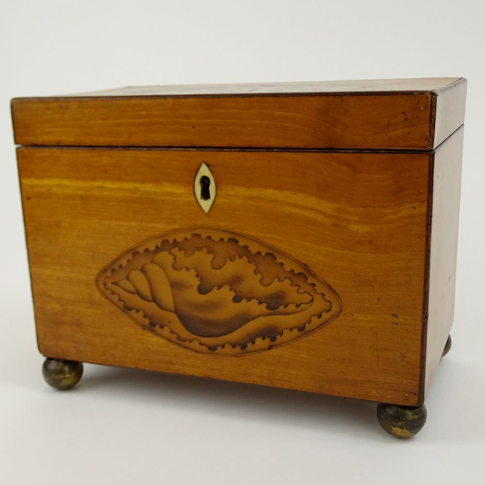 Antique English Satinwood and Boxwood Inlay Shell Motif: Antique English Satinwood and Boxwood Inlay Shell Motif Tea Caddy. Ball feet, bone escutcheon. Painted interior. Light wear or in good condition. Measures 5-1/2" x 7-1/4" x 4-1/4". Shipping $48.00