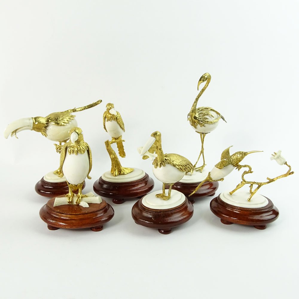 Boxed set of Ivory and 18K Gilt Metal Exotic Bird: Boxed set of Ivory and 18K Gilt Metal Exotic Bird Figurines. Each bird hand carved and mounted in 18K gold plated metal. Affixed to hard wood stands. Custom fitted box. Unsigned. Age cracks in Ivory,