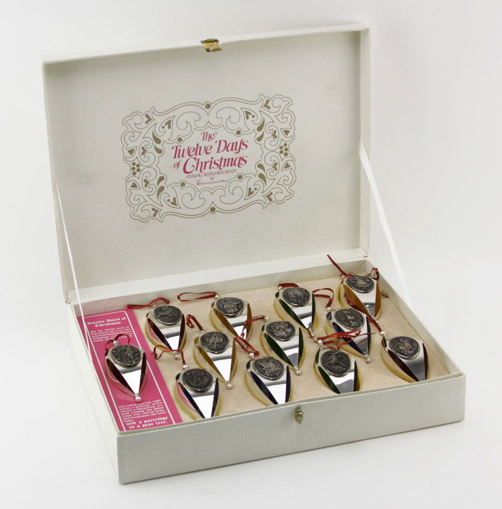 Twelve (12) International Silver, The Twelve Days of: Twelve (12) International Silver, The Twelve Days of Christmas, Sterling Christmas Ornaments in Original Box. Stamped. Each ornaments show some natural wear to surface, good condition. Each measures 6