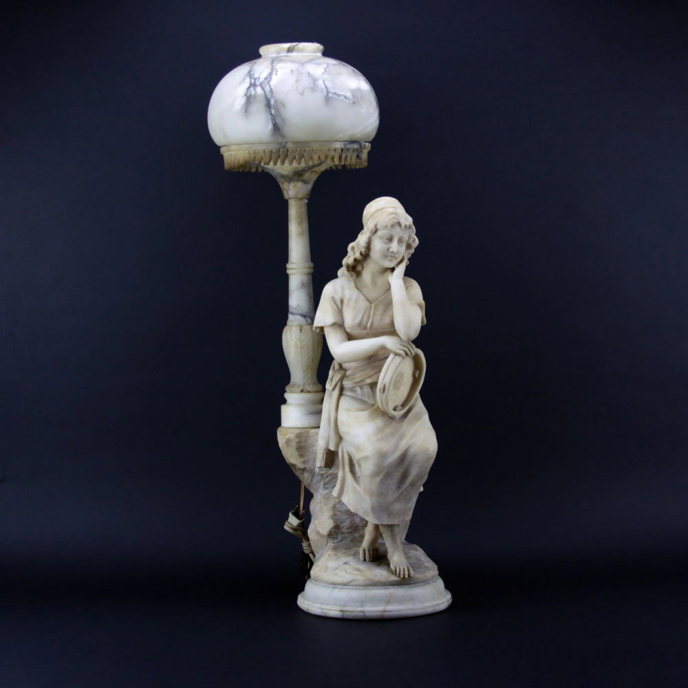 Antique Figural Alabaster Lamp. Features a gypsy with: Antique Figural Alabaster Lamp. Features a gypsy with tambourine. Unsigned. Repair to torch. Measures 31-1/2" H x 10" W. Shipping: Third party (estimate $500-$700)