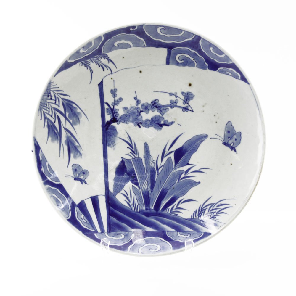 19th Century Japanese Arita Blue and White Porcelain: 19th Century Japanese Arita Blue and White Porcelain Charger. Decorated blue glaze butterfly and flower scene, blue glazed pattern and pin pricks on underside. Minor rubbing to surface, good condition