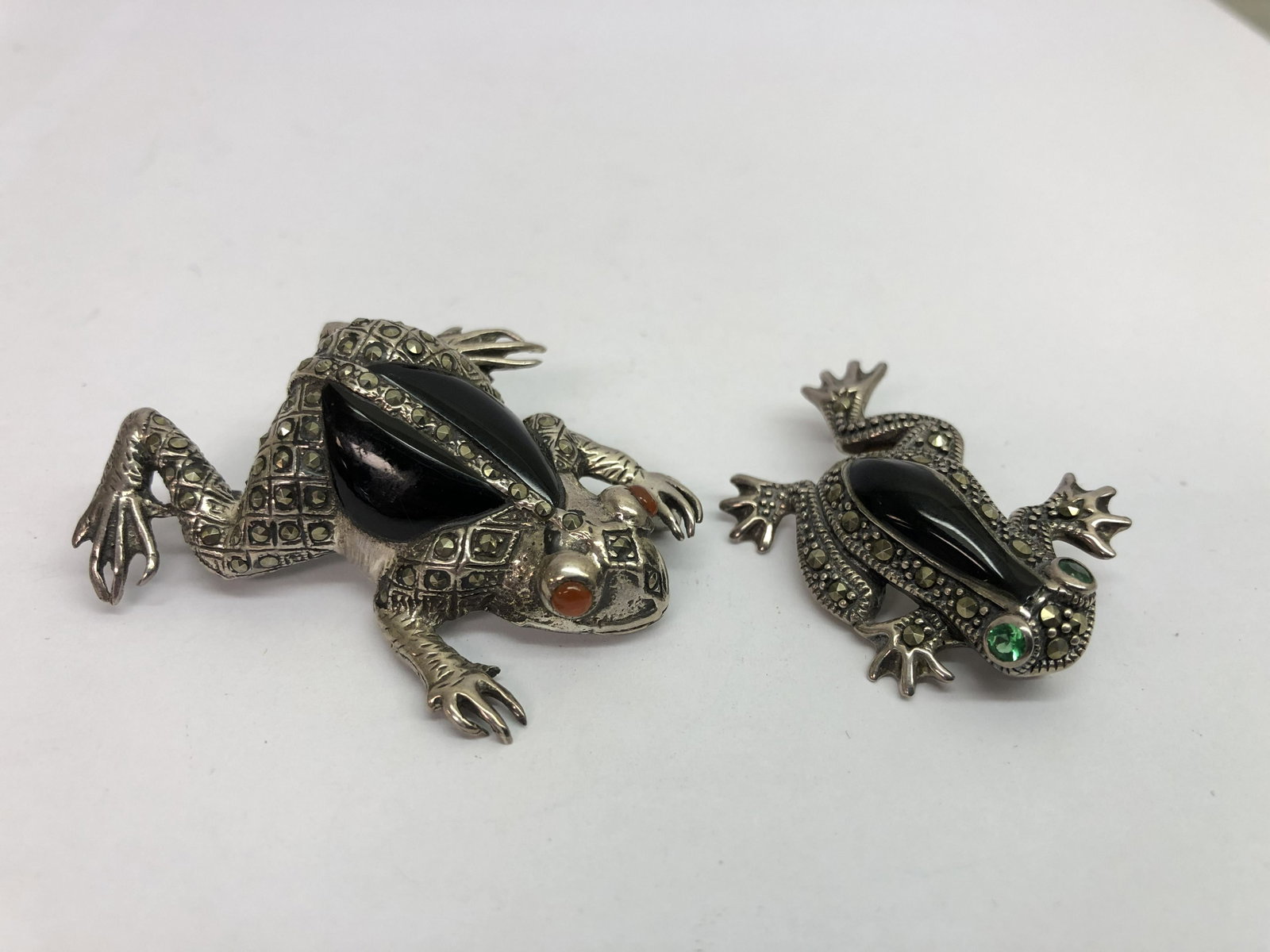 2 Vtg Sterling Marcasite Onyx Frog Brooches: 2 Vtg Sterling Marcasite Onyx Frog Brooches - 1 has Onyx & Red Stone Eyes 1.75'' Long + 1 has Green Eyes 1.25'' Long