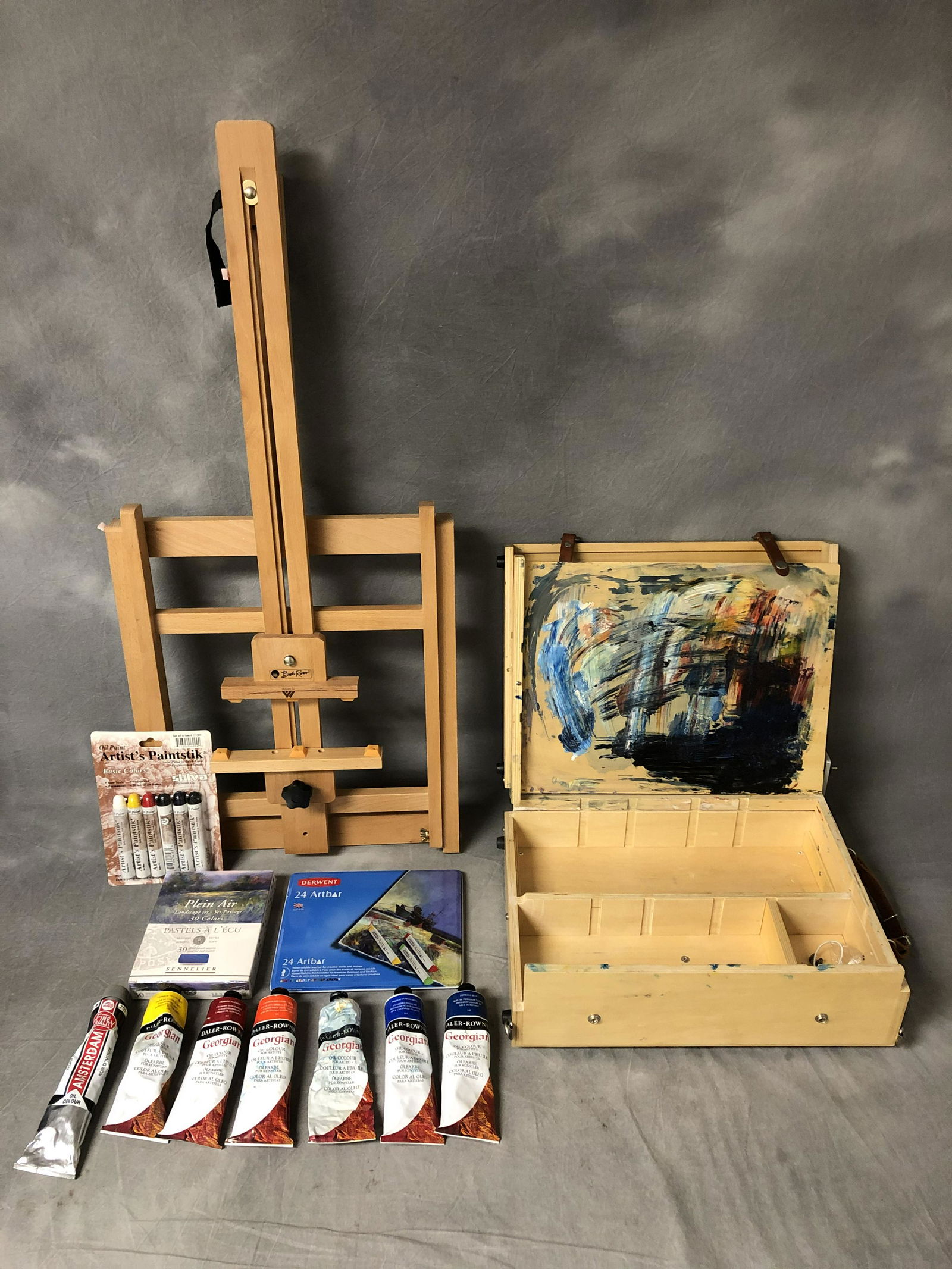 Asst Art Supplies, Easel, Oils & More - 'Weber' Bob: Asst Art Supplies, Easel, Oils & More - 'Weber' Bob Ross Easel, 'Guerilla Painter' Box w/ Daler Rowney Oils & Sennelier Pastels 30 Colors Sealed, Derwent Art Bars & More