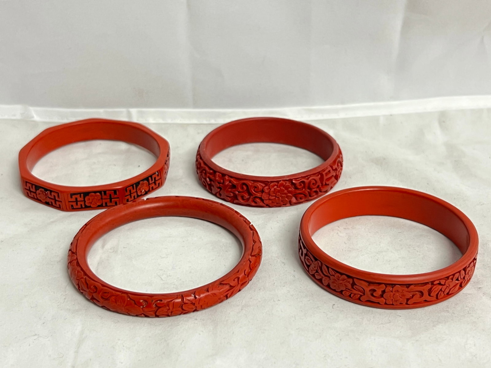 (4)Vintage Chinese Cinnabar Carved Bangles: (4)Vintage Chinese Cinnabar Carved Bangles