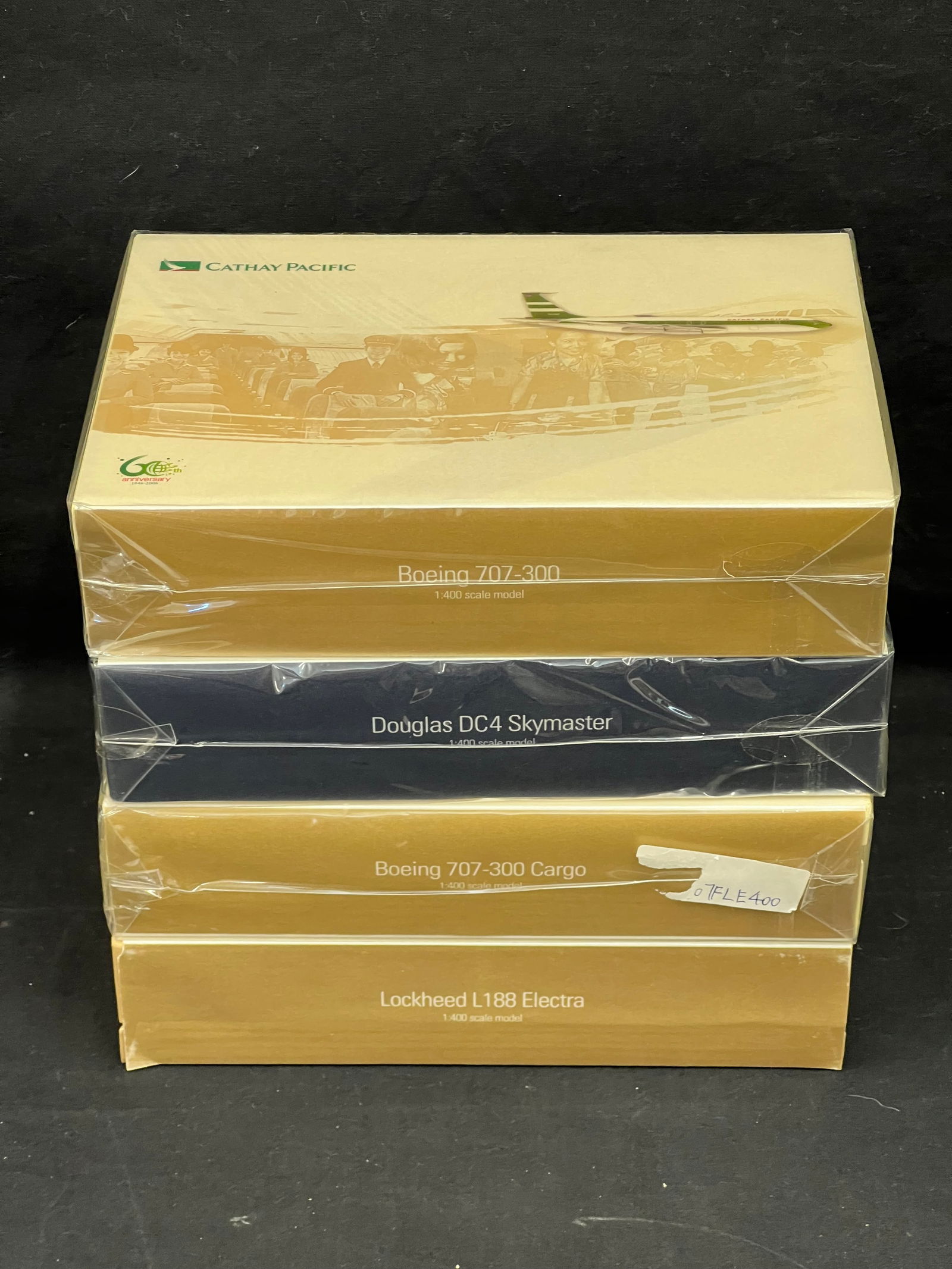 (4)Cathay Pacific 1:400 Scale 60th Anniv. Planes w/ COAs- All New - (3)Factory Sealed + (1)w/o: (4)Cathay Pacific 1:400 Scale 60th Anniv. Planes w/ COAs- All New - (3)Factory Sealed + (1)w/o Wrapping - All w/ Certificates + Numbered - Douglas DC4 Skymaster , (1)Lockheed L-188 Electra (Not Wrappe