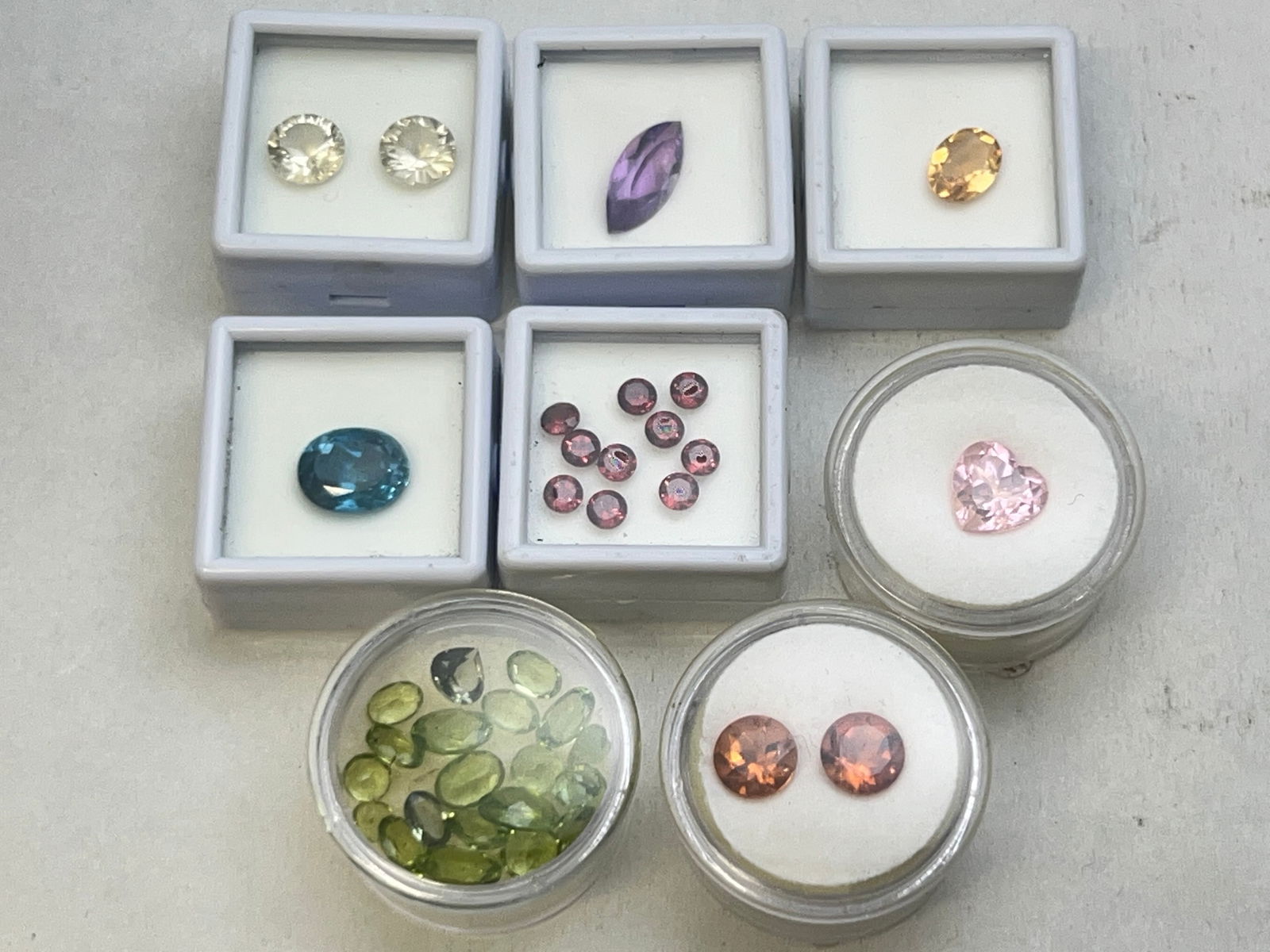 Lot Asst Gemstones in Various Cuts & Sizes - 5.40ct London Blue Topaz, 2.85ct Amethyst, 15cts Asst: Lot Asst Gemstones in Various Cuts & Sizes - 5.40ct London Blue Topaz, 2.85ct Amethyst, 15cts Asst Cut Peridot,1.55ct Citrine, 3.65ct Madeira Citrine Total of 2, 5.59ct Pink Garnet, (2)Quartz, Garnets