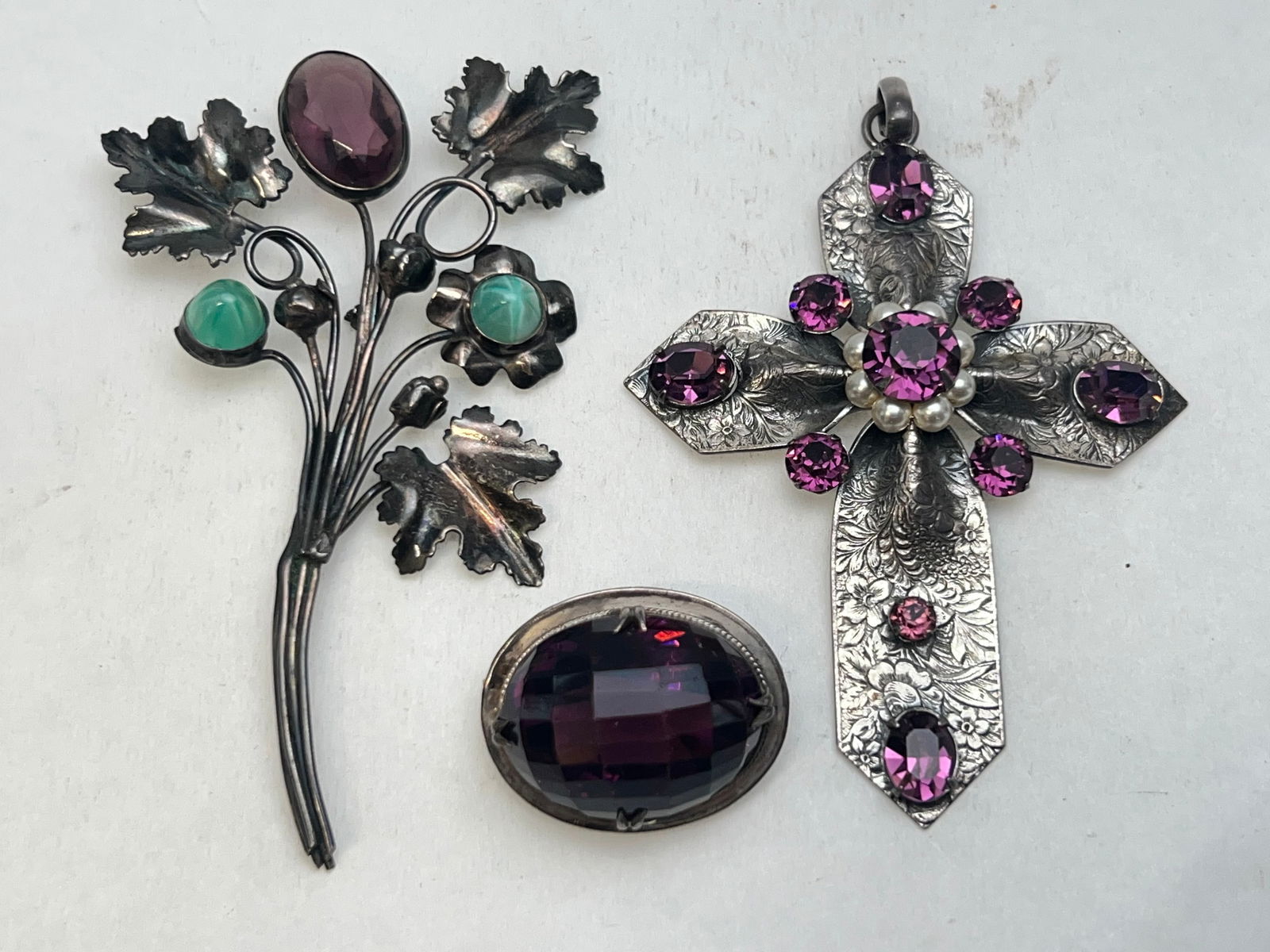 (3)Antique Sterling Silver Jewelry Pieces: (3)Antique Sterling Silver Jewelry Pieces - Sterling Brooch with Bouquet of Flowers with Purple , Celadon Glass Brooch 28mm X 21mm x 17mm Thick Purple Glass, Cross Etched Sterling Pendant