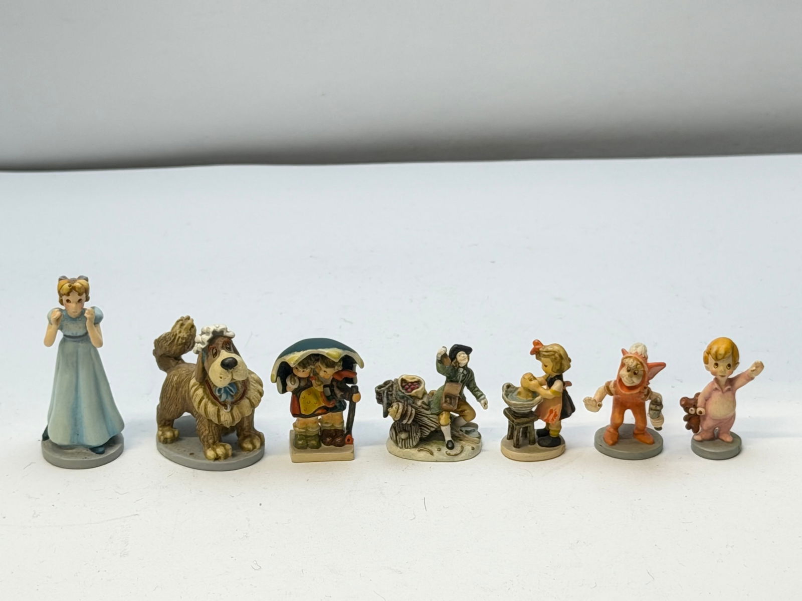 Miniature Goebel Figures - Disney Peter Pan & More: (4)Disney Peter Pan Characters - 185P Wendy, 189P Nana, 187P Michael, 191P Lost Boy & (3) - 251P Stormy Weather, Limited Ed. 742P & 252P Doll Bath