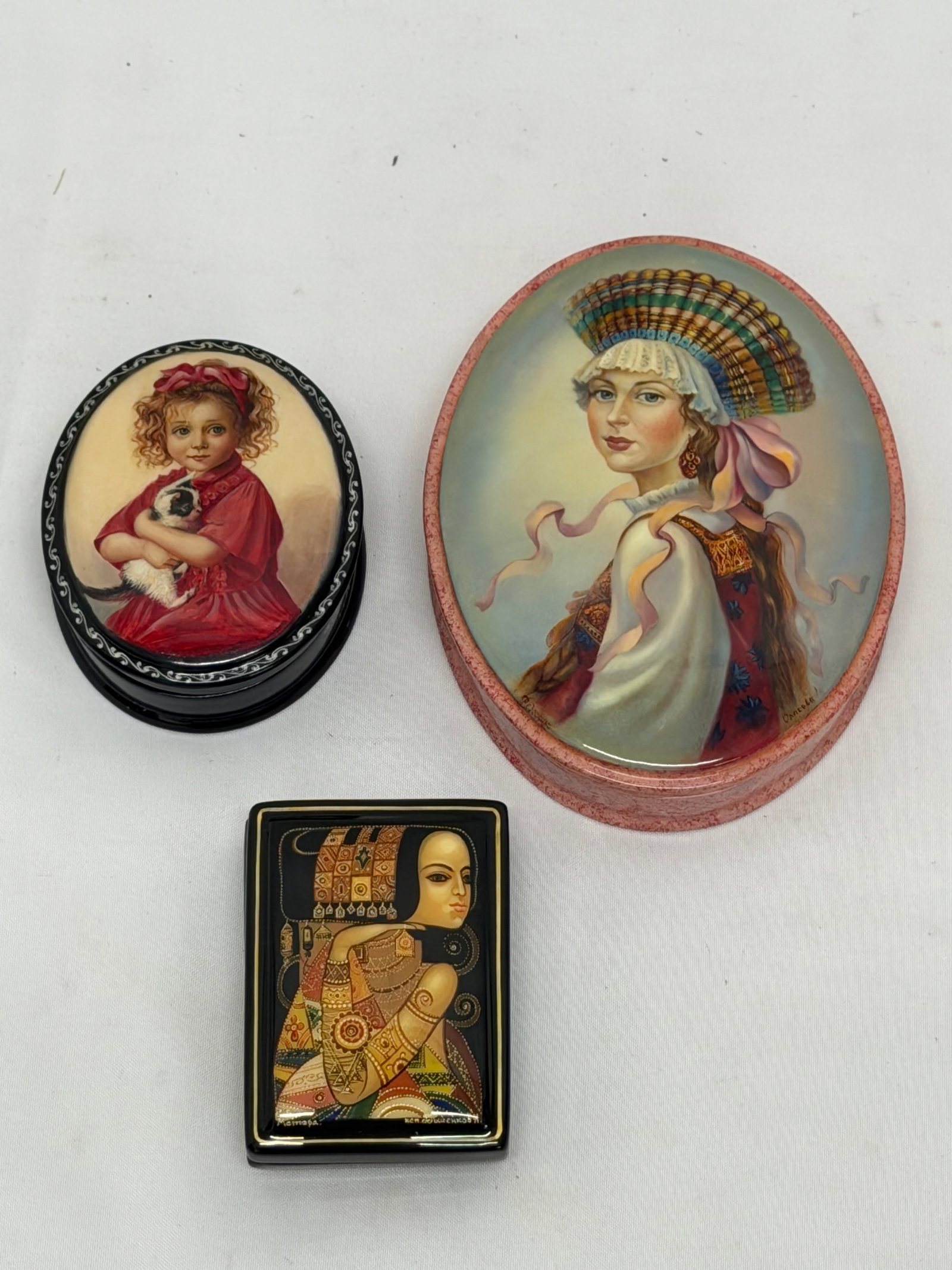 (3)Russian School Hand Painted Lacquered Boxes: (1)Girl with Kitten & Child 3" x 2.5" x 1.25", (1)Lady 2.75" x 2" x 1", (1)Trinket with Lady & Ribbon 3.75" x 4.75" x 1.25"