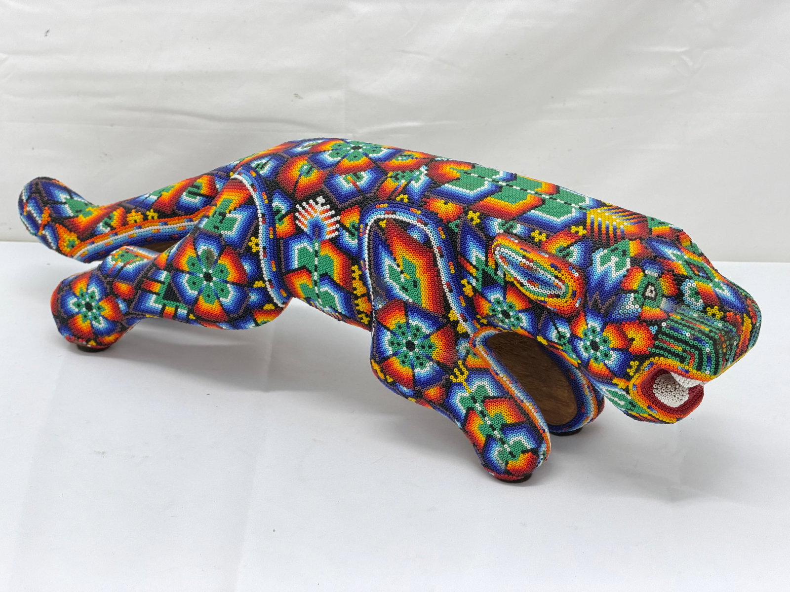 Huichol Tribal Folk Art Beaded Jaguar on Wood 18.5" x 4" x 6": Huichol Beaded Art Jaguar with Beeswax & Pine Resin - Symbolizes Strength / Protection / Connection to Spiritual Realm - Geometric Patterns with Flowers, Peyote - All one piece
