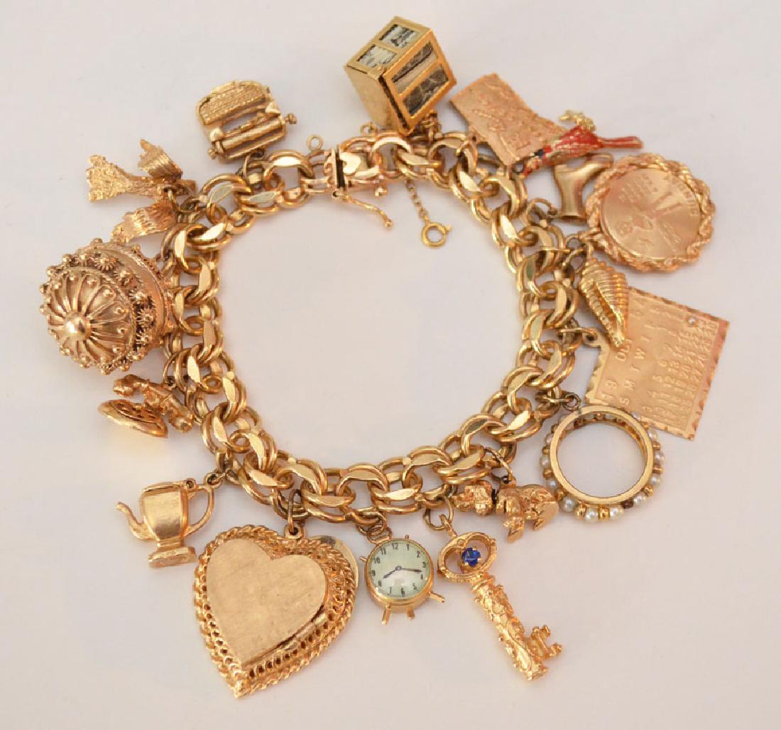 Exceptional 14 K Gold Charm Bracelets with 18 Charms: Measures 7.5" long and weighs 61.5dwt.