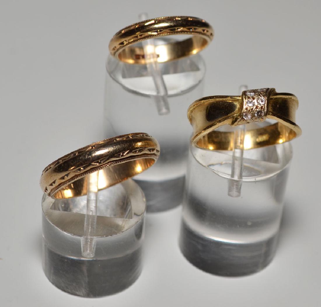Three 14k Gold Rings (Wedding Bands, Diamond): Gross weight is 7.1dwt. Ribbon style ring with diamonds sz 7.5, bigger band8.75, smaller 6.25.