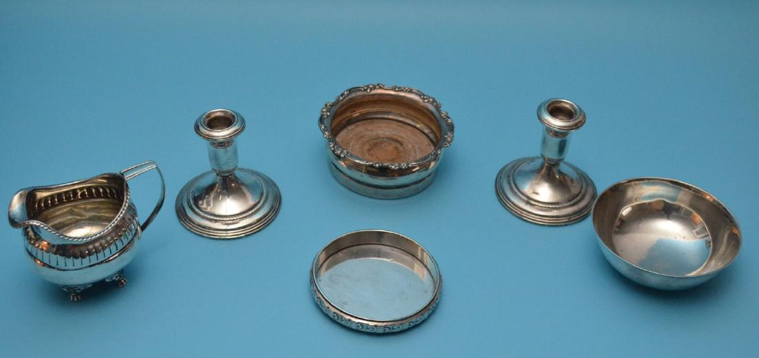 Lot Of Sterling Silver Table Accessories: Lot includes: wine bottle coaster (Hartdegen 5" diameter), Sam Giovanni bottle coaster, International bowl, 2 weighted candle holders, and an english creamer, 3 weighable pieces weigh 435 grams