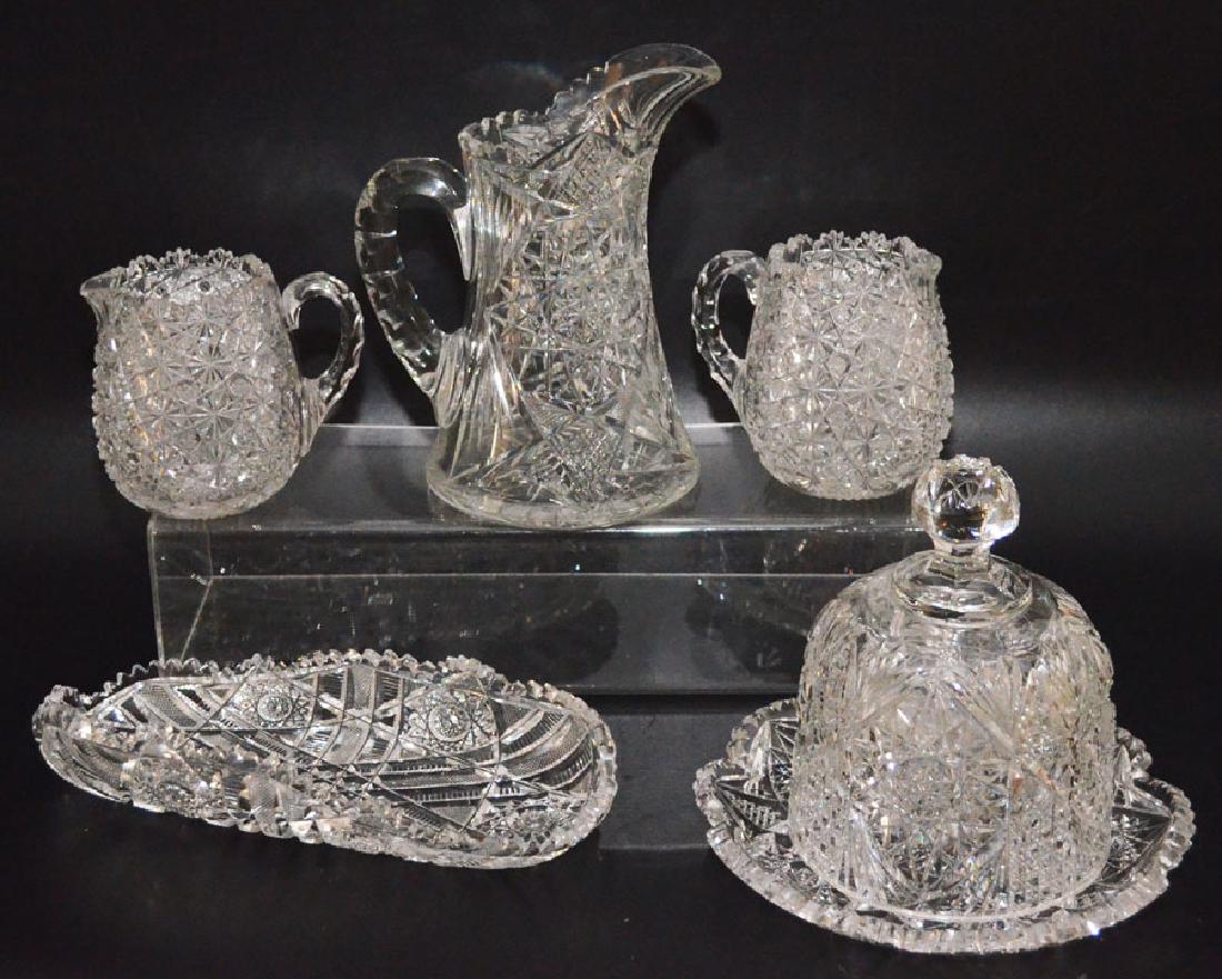Lot Of Antique Cut Crystal ( Pitcher , Creamers): Lot includes two matching pitchers 4 7/8 inches tall, celery tray 12 inches long by 4.5 inches wide, large pitcher 9 1/8" tall to the tallest point and cheese dome with dish 7.5 inches tall by 9 inche
