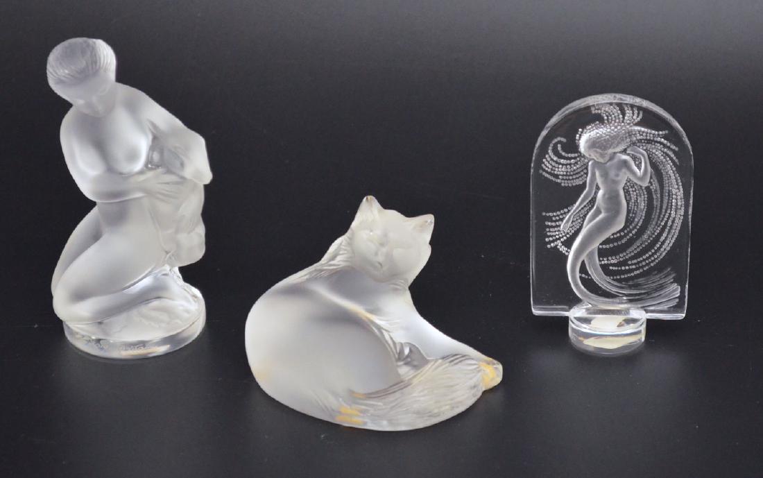 3 Lalique Art Glass Pieces (Cat, Mermaid, Nude): Lot includes: Nude woman holding a lmap (4.5"t), cat (2"t), and a mermaid wax seal (3.75"t)