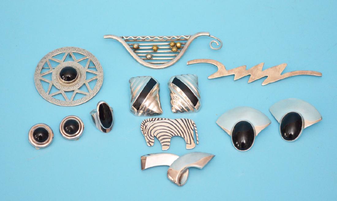 Great lot of Sterling Silver & Onyx Jewelry: Lot includes: 3 pairs of clip earrings, a zebra pins, 3 abstract pins, a round onyx pin (2.25"diameter) and a ring (approx. 6.5). No credit card payments accepted via phone for jewelry lots.