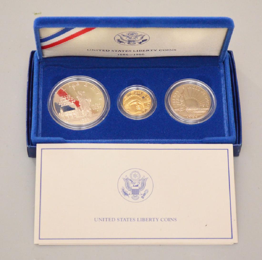 Set of (3) 1986 United States Liberty Coins: One Set of (3) 1986 United States Liberty Coins. (1) 1986-W $5 Status of Liberty Gold Coin, (1) 1986-S $1 Statue of Liberty Silver Dollar, and (1) 1986-S Statue of Liberty Half Dollar Coin.