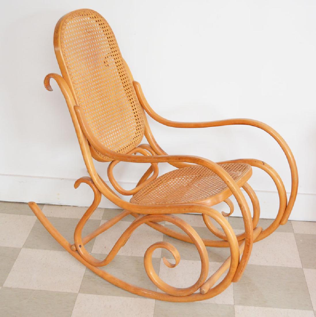 Thonet Bentwood Rocking Chair: Measures 40" tall x 20" wide x approx. 40" deep. Seat height of 19". In estate found condition, has some fading on arms, some staining.