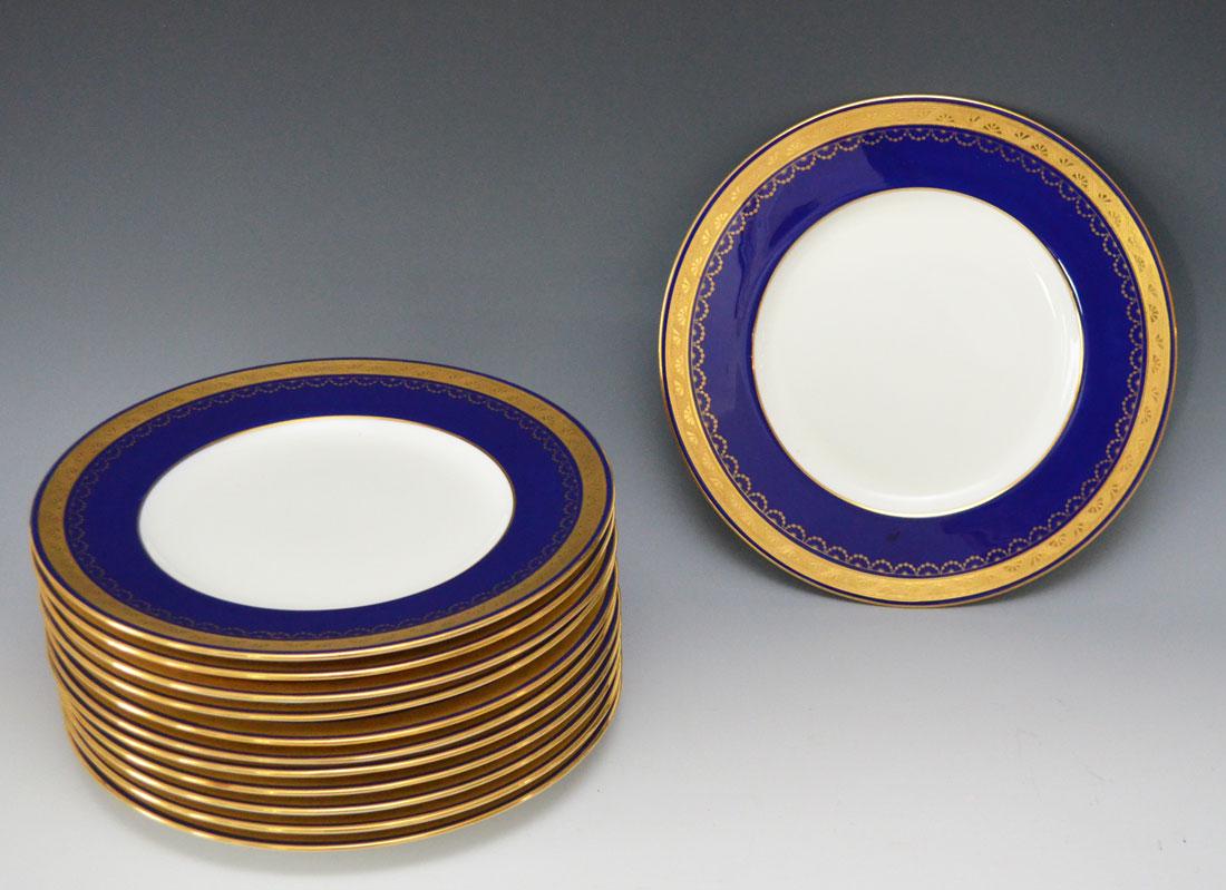 12 Exquisite Gold Encrusted Cobalt Blue Minton's Plates: 12 Plates. They measure 10 5/8" diameter. No chips or cracks, some utensil marks, one plate has a deeper scratch in the cobalt portion.