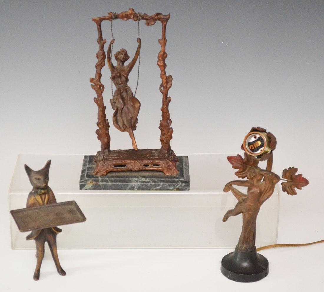 Lot Of Three Bronzes: Lot includes: Figural fox card tray (7 7/8"t), Art Nouveau style woman on swing (10.5" t) and Art Nouveau woman dancing lamp (9.5"t).
