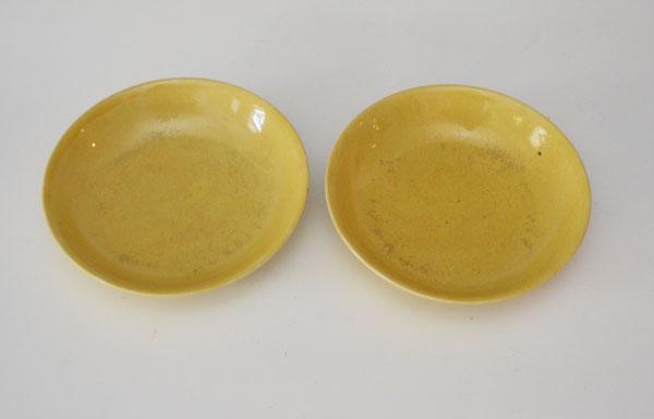 2 Antique Chinese Porcelain Imperial Yellow Bowls: Both bowls feature imperial dragons in the center and around the bottom rim of the bowls. They measure 7 5/8" diameter. One has a crack as pictured. Both have wear to interior glaze.