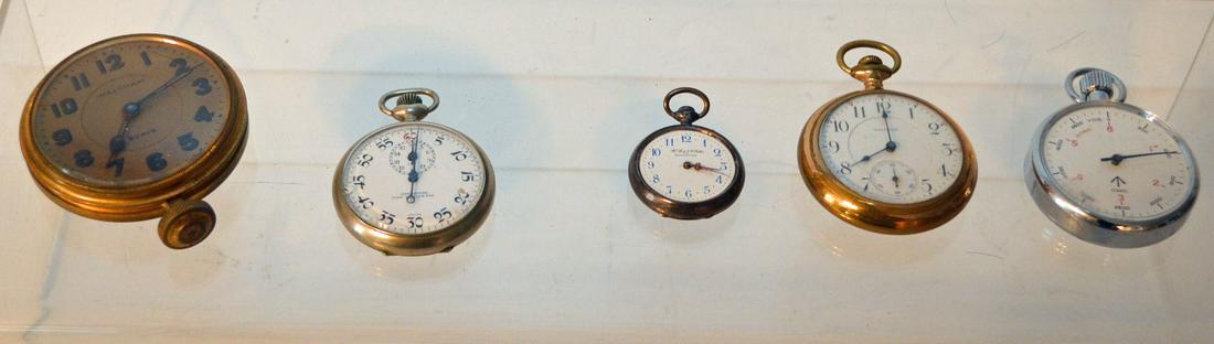 5 Antique Pocket Watches: Lot includes: Speedway non magnetic, Waltham car clock, Waltham open face, stop watch, and a WH & JC Dotter Philadelphia ladies watch. They range from 1.25" x 2.75" diameter.