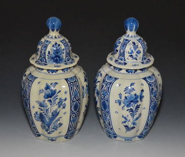 Pair of Royal Delft Covered Urns: Royal Delft (De Porceleyne Fles). They measure approx. 12.5" tall total. One has more of a yellow hue than the other.