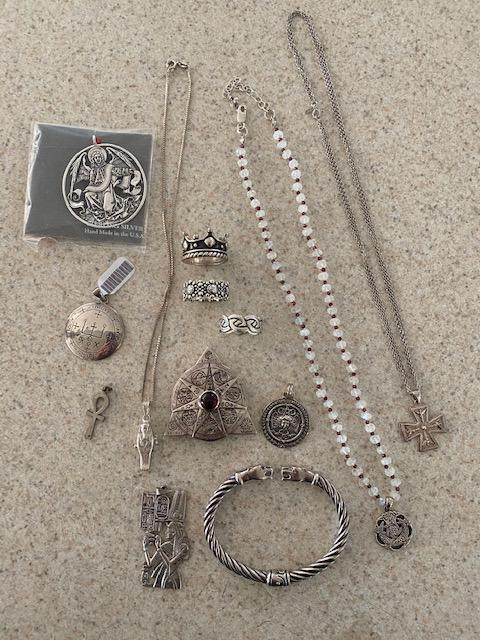 Group of Metaphysical Sterling Jewelry: Lot of sterling jewelry from the estate of paranormal investigator and author Rosemary Guiley. Includes: Armadel Seal of Raphael, Egyptian sarcophagus, Medusa, Celtic, Panter Bracelet, Azoph of the ph