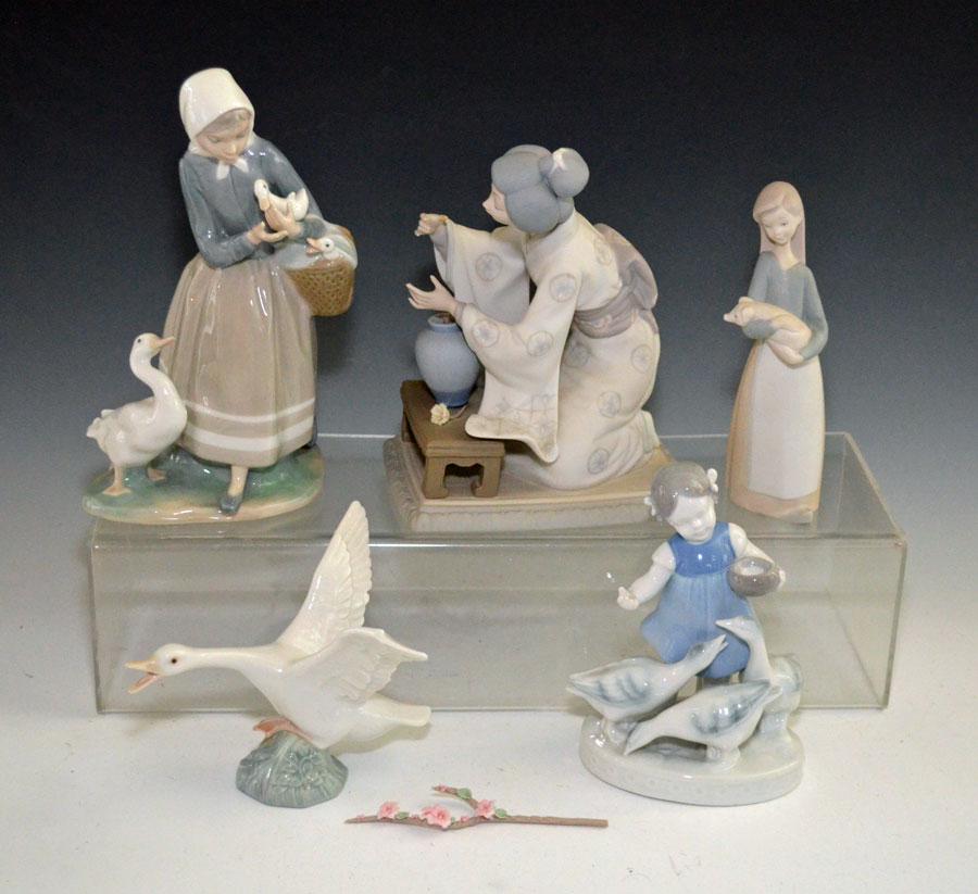 Group Of Mostly Lladro Porcelain Figurines: Geisha Girl (7.5", damaged flower, has factory replacement), Girl with Pig (6.75") Goose (4.5"), Girl with Geese (9"), Gerold Porcelain Girl with Geese (6.5")