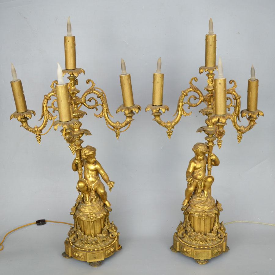 Pair of Grand D'Ore Bronze Putti Candelabras: These lamps are approximately 32" tall. 15 1/2" long at widest spot and the depth is approximately 12 1/2" deep. May need rewiring, one needs some tightening of the sections.