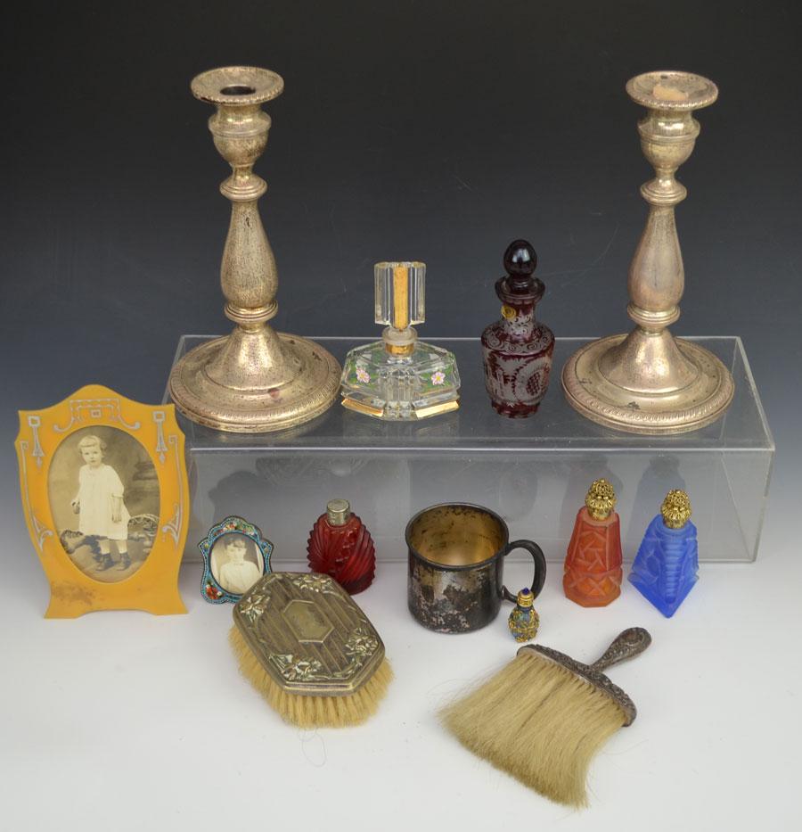 Eclectic Sterling & Lady's Lot: this lot contains 6 perfume bottles ranging from 1 3/4" to 5 1/8". 2 frames with old photos, 1 amston sterling baby cup, pair of weighted sterling candlesticks ( reinforced with cement) they are 8 3/4