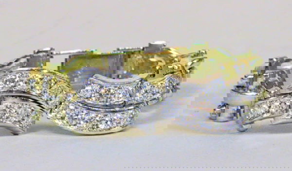 Platinum and 14k Gold and Diamond Bracelet: 14k yellow and white gold pinned bar link bracelet with two center opposing double curves set with 20-10pt faceted diamonds. The diamonds encased in a platinum setting. Total weight 13dwt. Diamond tot