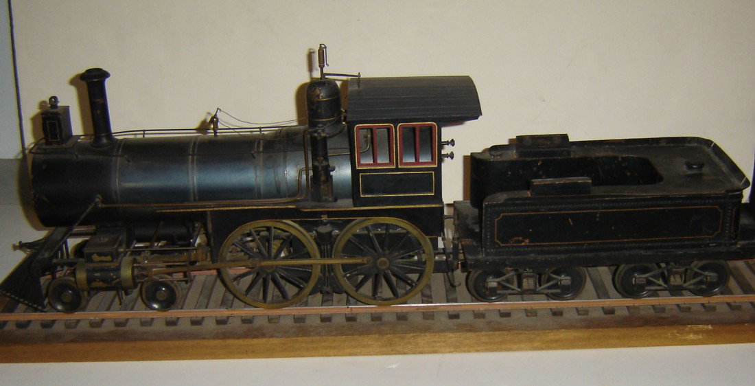 19th Large Live Steam Engine Locomotive Model: 19th Large Live Steam Engine Model. The engine measures 12" h x 24" long. The tender measures 6 1/2" h x 14" long. 4 1/2 gauge.