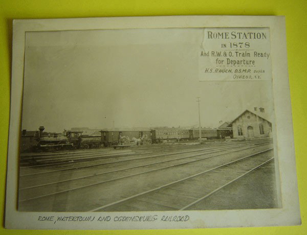 1878 Photo Of Rome, New York Station: Rome station in 1878 And R.W. & O. Train Ready for departure H.S. Rauch, D.S.M.P. owner Oswego, N.Y. It measures 6 1/2 x 9. Matted 8 x 10.