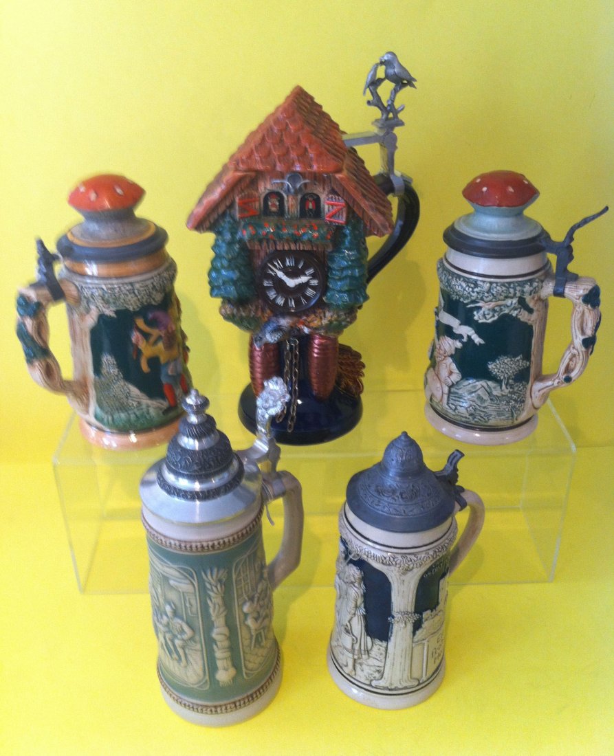 Lot Of 5 Interesting Beer Steins: Lot Of 5 Interesting Beer Steins. The coo coo clock stein is on the internet as the dumbest stein made because their is no way to really drink it. They measure 8.5, 9, 10 3/4, 8.5, 11.5 inches tall.