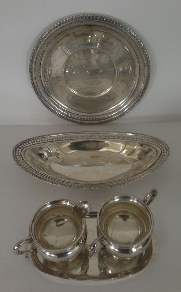 Lot Of 5 Sterling Silver Silver Table Accessories: The large international sterling plate measures 10 inches in diameter and grosses 9.69 ozt., the sterling bowl measures 6 x 12 inches and grosses 5.04 ozt., the sterling small tray measures 4 3/4 x 8 